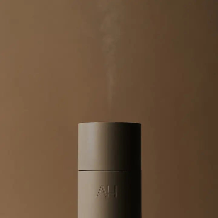A fine dry mist rising from the top of an Aura Scent Diffuser