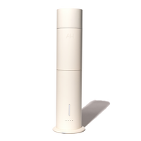 A white Aura Scent Diffuser standing upright with a cylindrical shape.